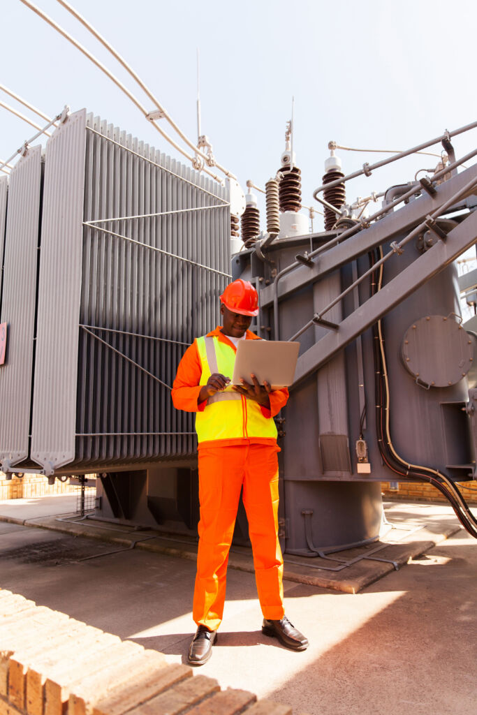professional african power company technical worker using laptop computer - Transformer Dispatch and Delivery